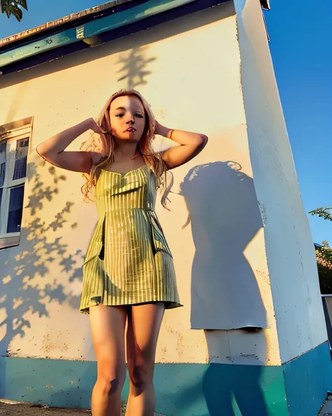 blond woman in an green dress standing in front of a blue building, by Anna Haifisch, shot at golden hour, at golden hour, golden hour sunlight, the girl and the sun, in the sun, golden hour sun, by Andrée Ruellan, malika favre, nice afternoon lighting