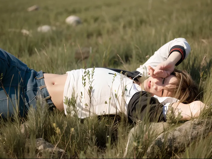 A boy lying on grass with hand on his face