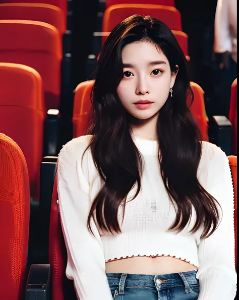 Cinematic Photo of a beautiful korean fashion model, 20 years old, perfect body, perfect skin, loose long hair, micro curls, tight jeans, white crop top, knit long sleeve, sitting in movie theater