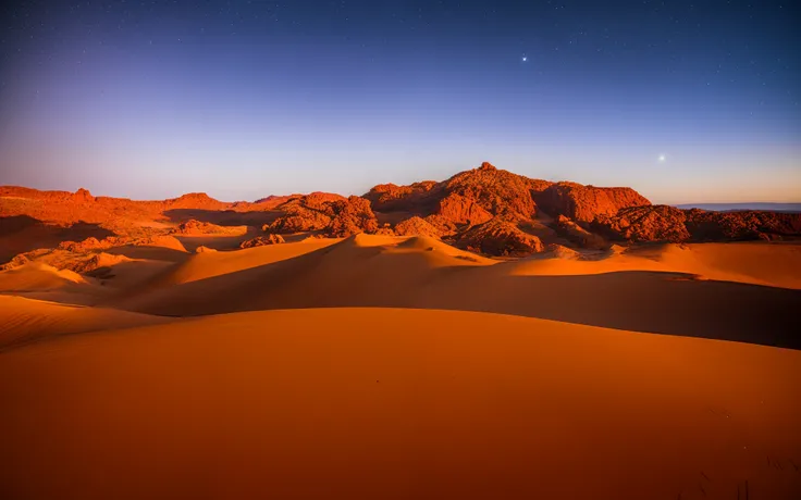 Desert in a starry sky behind