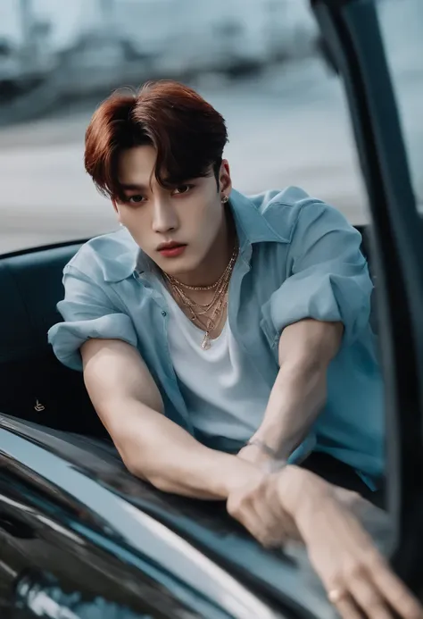 Jungkook with medium hair and a cigarette in his hands is sitting on top of a car wearing a transparent shirt that highlights his muscles