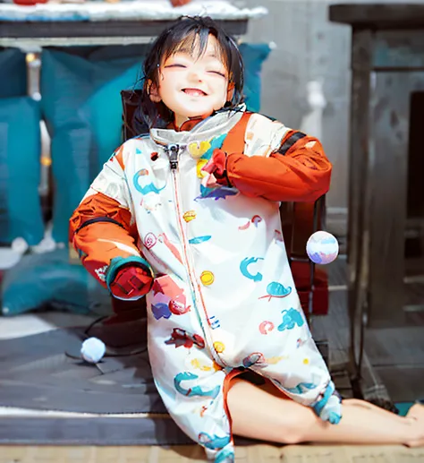 Close-up of a Chinese child wearing a sleeping bag，Show off her adorable five little fingers and five little feet，The child has a smile on his face，There is a ball in the air, cute design, Fashionab, white and teal garment, Adorable, Warmth, sleeping bag, ...