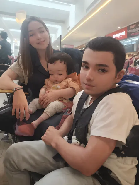 There are two people sitting in a chair with a baby, imagem de qualidade muito baixa, Directed by: Nandor Soldier, em um shopping, em um shopping, with a kid, babies in her lap, aparecer em um shopping center, Upload de alta qualidade, mateus 9 5, foto de ...