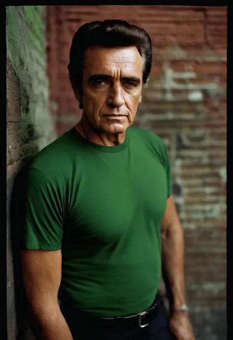 Johnny Cash, the man wearing a black t-shirt, short sleeve, stands in front of a graphitti street. His hands are casually tucked into his pockets as he stares directly into the camera, his intense gaze capturing the attention of all who see it. The green l...