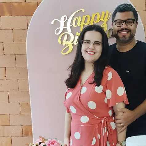 Smiling couple standing in front of a happy birthday sign, Casal feliz, Directed by: Márta Lacza, Directed by: Nandor Soldier, Malika Favre, In Sao Paulo, Lovely couple, edu souza, he is! cerca de 3 0 anos de idade, andrea rocha, happy birthday, Directed b...