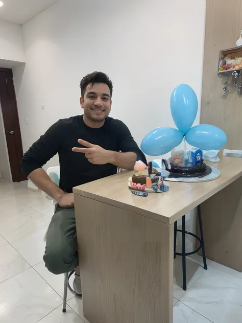 Person sitting at table with birthday cake