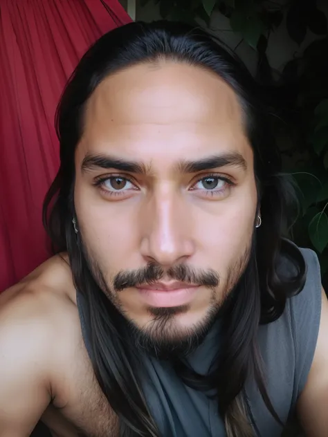 Indigenous man with long hair and beard, staring directly at camera, Looking directly into the camera. 37 anos. Vestido.