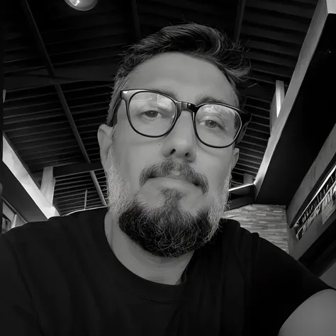 Man with glasses and BarBa sitting in restaurant, with glasses and goatee, david rios ferreira, taken in the early 2020s, Fernando Guerra, with nerdy glasses and goatee, Federico Pelat, Fotografia selfie 8k, B&w foto, andres rios, Filipe Starck, john romit...