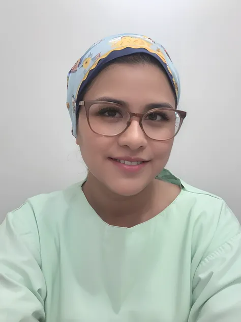 Brunette woman in operating theatre outfit wearing a headscarf and glasses