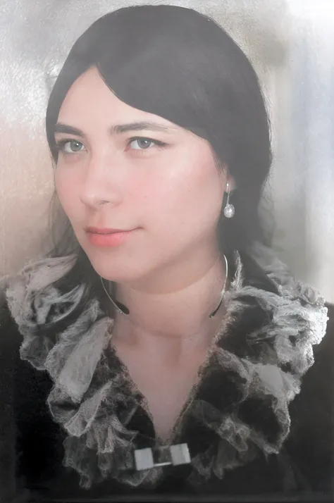 There is a woman with black hair, black eyes, fair skin, wears a silver choker around her neck, black dress with transparent white and black cedar collar, detailed hair, deitaled face