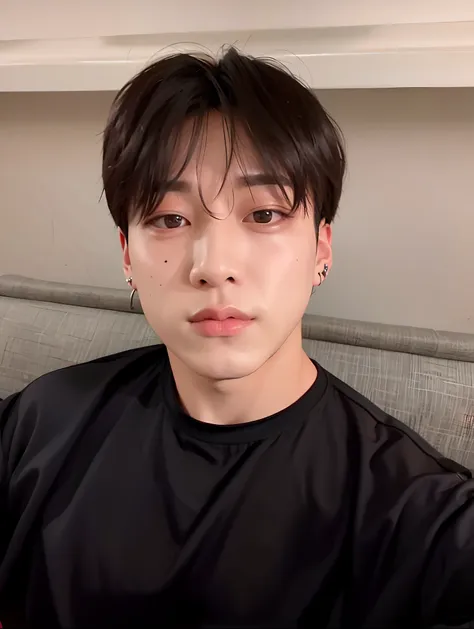 there's a man in a black shirt sitting on a couch, jungkook\labios delgados, jungkook\double right eyelid, jungkook, hyung tae, ...