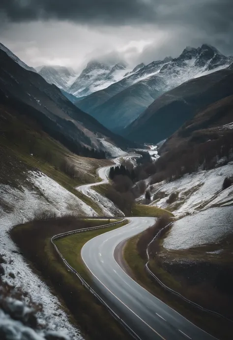 A mountainous road with winding curves, offering breathtaking views of snow-capped peaks and lush green valleys below.