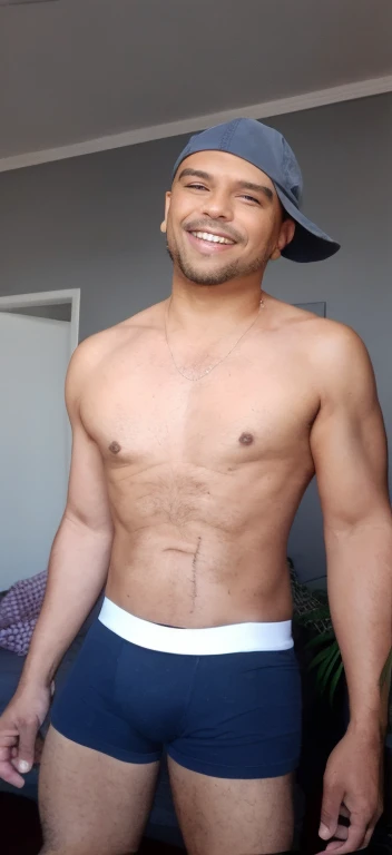 Man in azuk hat and underwear, Cap to the side and smiling