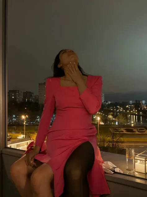 A girl in a dress sits on the ledge of a balcony, Modern balcony, stylish interior, Night outside the window