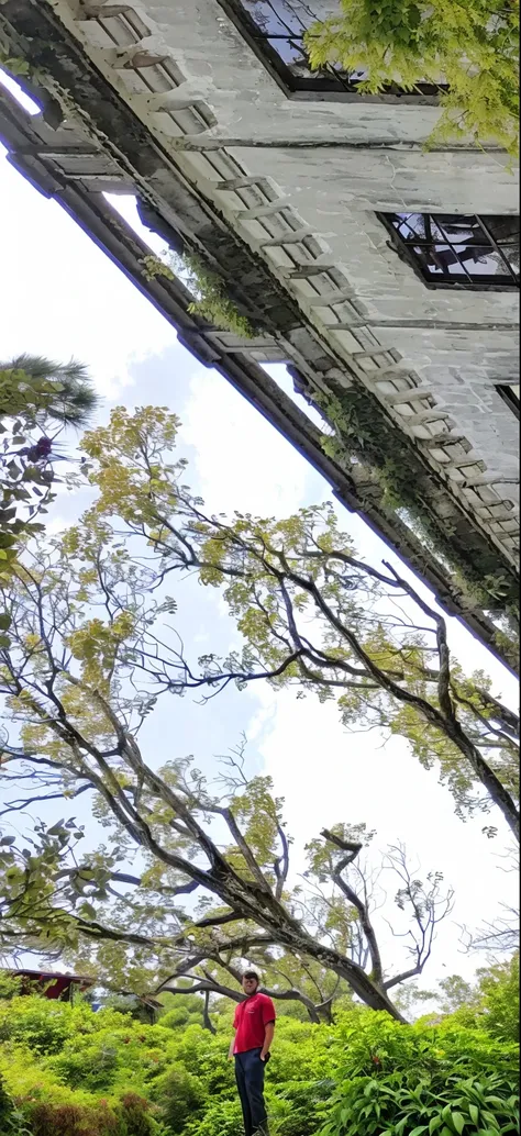 there is a man standing in front of a building with a red shirt, ruins in the background, amidst of nature fully covered, front side, at an ancient city, old building, colonial house in background, amidst nature, in front of the house, discovered photo, ag...