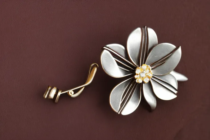 close-up, metal brooch with flower design