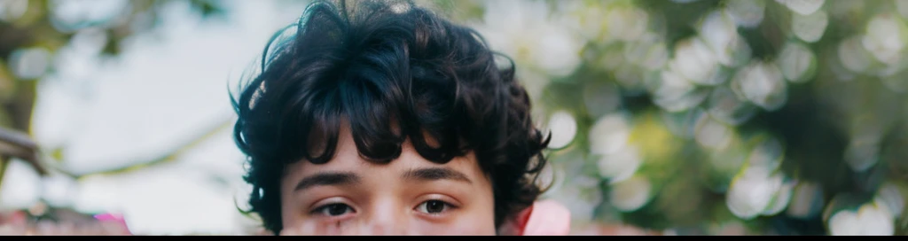 a boy with curly hair