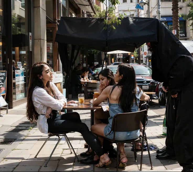 There were two women sitting at a table outside the restaurant,