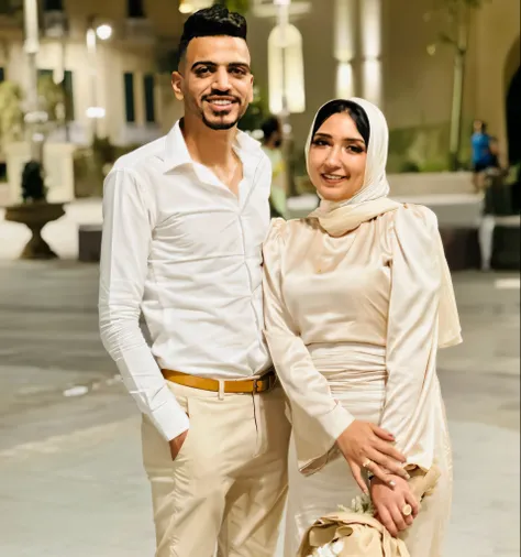 There are two people standing together in the courtyard with a building in the background, lovely couple, Happy couple, Very, very low quality image, couple, couple pose, Taken in 2022, khyzyl saleem, Interlocking full body view, Full body snapshot, A very...