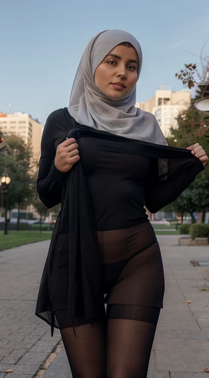 A muslin woman lifting her Burka, showing legs and tights, wearing a pantyhose, park in the background