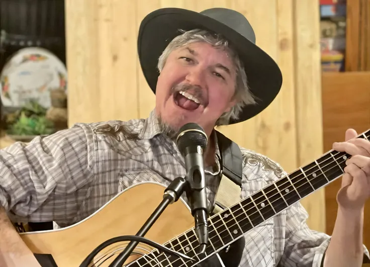 man with a hat and a guitar in a recording studio, grey hair and a black hat, bill rizer, 2 0 2 1, 2021, profile pic, by Winona Nelson, by Leland Bell, album art, singer songwriter, derek ridgers, 2022, 2 0 2 2, performing on stage, album