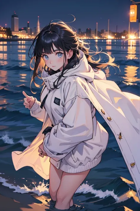 beautiful young girl in oversized winter clothes and hair floating on the beach at night,