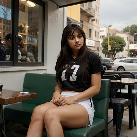 Layla, the dedicated football enthusiast, takes a moment of calm before the game, sitting outside a restaurant