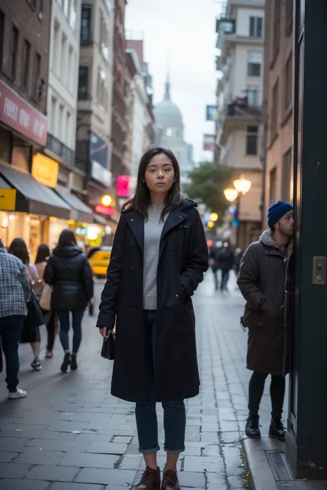 A poorly lit night photo of a woman outside in the city at night