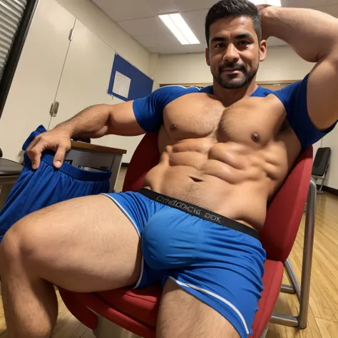 40 year old physical education teacher, en boxers, with a very large and long bulge in the crotch, sentado en una silla, front facing camera, guapo latino.