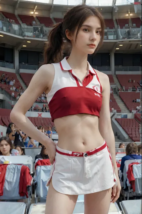 Very skinny European 23 years old woman, short brown wavy hair in a ponytail, flat chested, narrow hips, slender, wearing red and white cheerleader polo and matching miniskirt. Crowded huge stadium as backdrop. Full body shot.