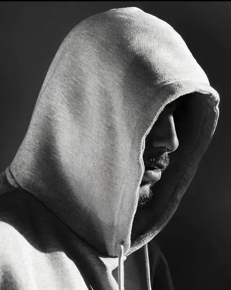 faaris azura in a hooded sweatshirt looking at his cell phone, in a hoodie, in a hood, like a catalog photograph, wearing a hood...