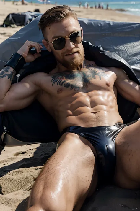 conor mcgregor smiling in shades, in tight shiny leather speedos, manspread on the beach.