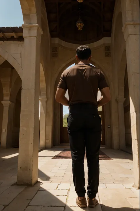 A man wearing black pants and a brown tshirt standing in front of a mosque, with a view of the back.

Tags: 
man, black pants, brown tshirt, mosque, back view, peaceful atmosphere, architectural beauty, serene setting, religious symbol, cultural heritage, ...