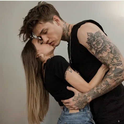 tattooed guy kisses girl
