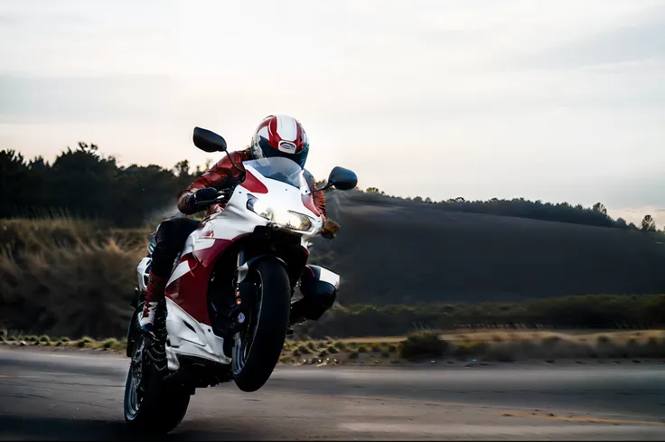 motorcycle rider in a white and red outfit riding on a road, wide shoot, kawasaki, wide screenshot, triumph, wideshot, panning s...