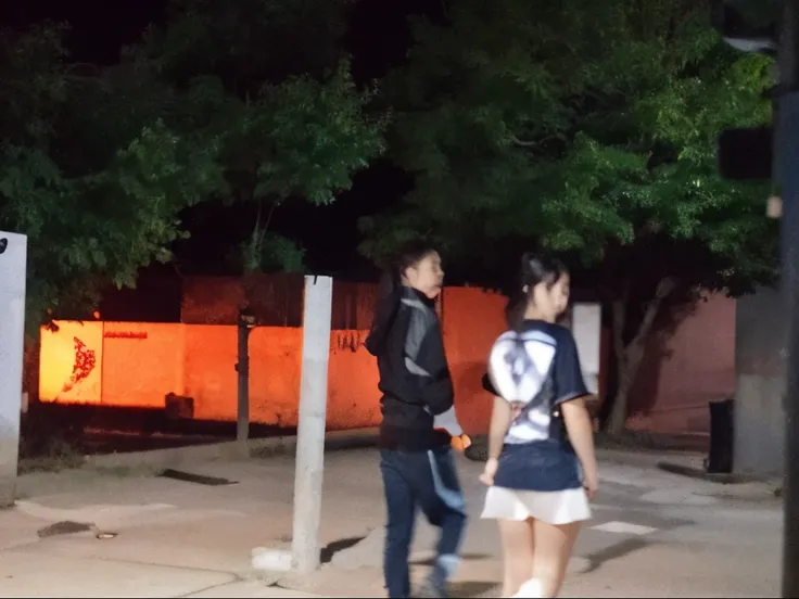 CCTV footage, two teenagers walking on the street at night