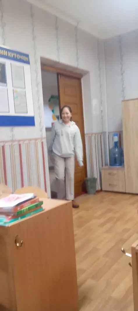 there is a woman стоI in a room with a desk and a chair, стоI in class, dancing in the background, стоI!!, I throw myself at the camera :4, she is dancing, I&#39;I&#39;m going to the camera, стоI on two legs, she is dancing. realistic, I run to the camera,...