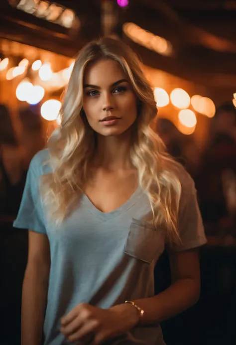 Very beautiful blonde 22 year old wearing a t-shirt looking straight into the camera in a club