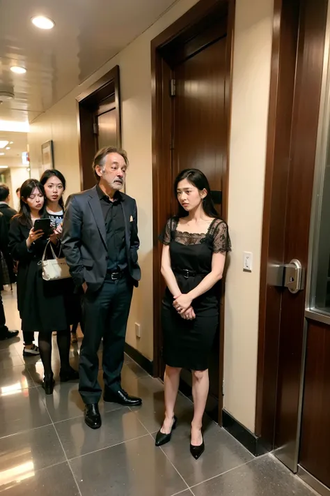  A group of people in the hotel lobby are waiting for the elevator with very anxious expressions 
