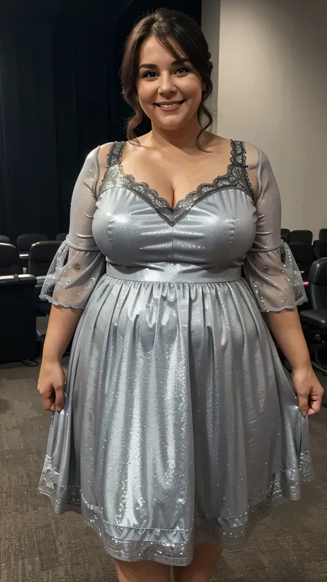 A beautiful and hot almost chubby mature  woman.who is wearing a shiny gray dress with lace-like sleeves and standing in the cinema hall. A smiling face