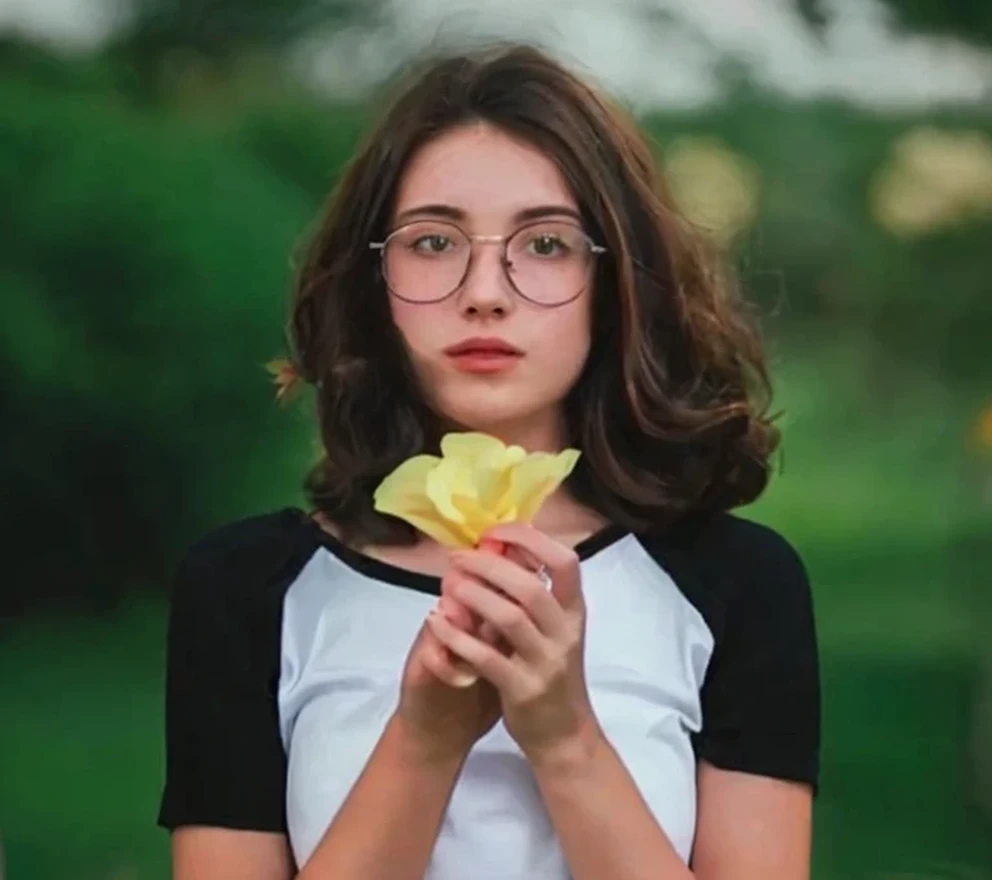 Girl holding flowers outdoor scene