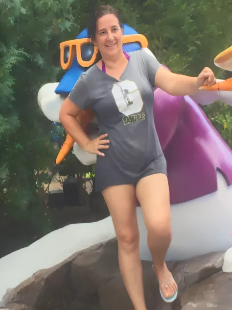 woman in gray shirt and shorts standing next to a large penguin statue, vacation photo, photo from the back, having a great time, 3 0 years old woman, 30 years old woman, posing like a statue, profile image, photo taken in 2016, fit pic, 40 years old women...