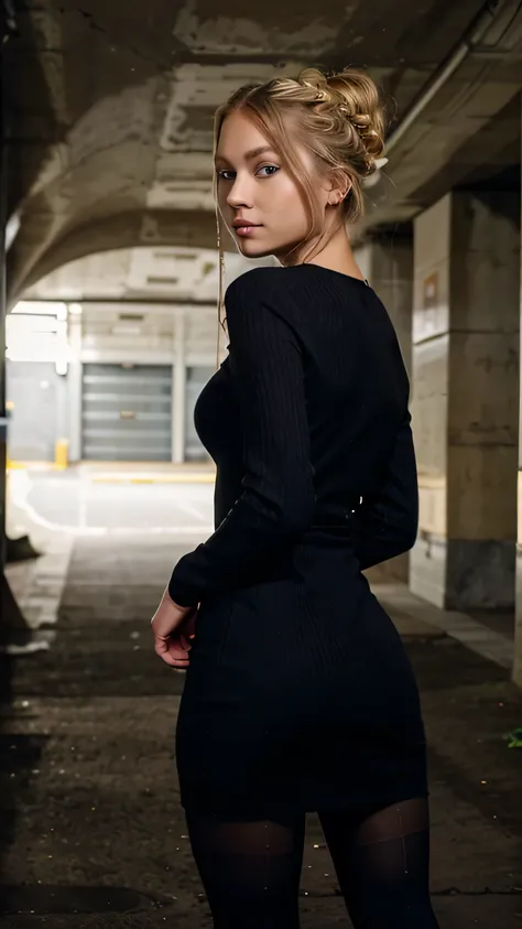 a young woman with long light blonde hair tied in a bun and blue eyes, she wears a long black ribbed dress and black tights, she is standing posing with her back for the photo with a seductive look in an underground parking lot building