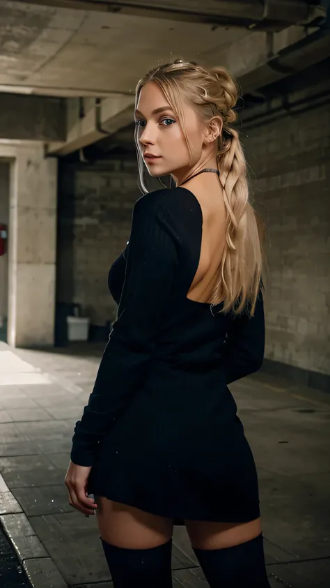 a young woman with long light blonde hair tied in a bun and blue eyes, she wears a long black ribbed dress and black tights, she is standing posing with her back for the photo with a seductive look in an underground parking lot building