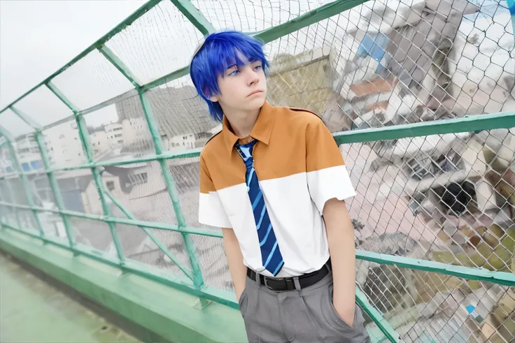 There is a 16-year-old boy with blue hair, blue eyes, on top of a school building, he is thoughtful, somewhat sad, looking at the city.