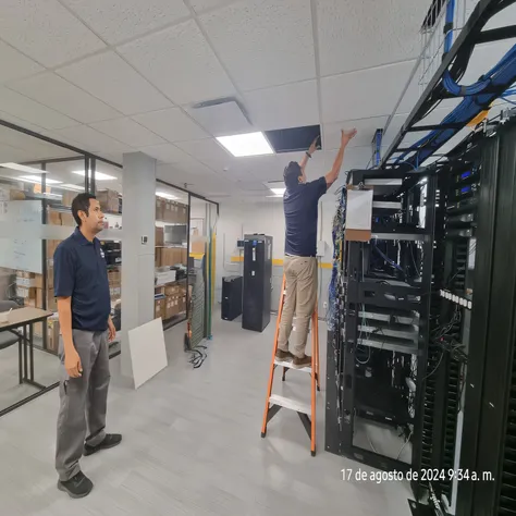 Two men are working on a server in a large room., in data center, data center, in detailed data center, 8K. filling the view, extreamly detailed data center, Rhythm in the server room, maintenance photo, Suspended Roof, in realistic data center, decadent, ...