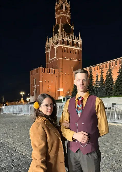 a man and a woman are standing in front of a tall building, in Moscow centre, red square, the photo was taken at night, Moscow, red square Moscow, Russian clothes, with a high-rise building in Stalinist style, russia in 2 0 2 1, Russian style, Moscow kreml...