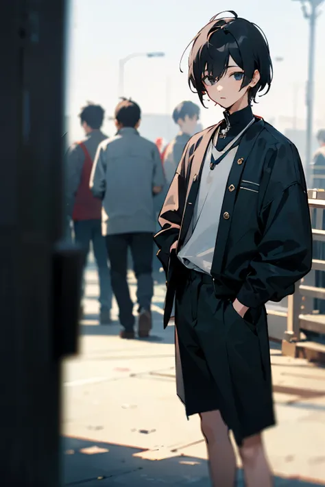 Boy, black hair, clothes black, looking at the camera. The background is blurred in the back.