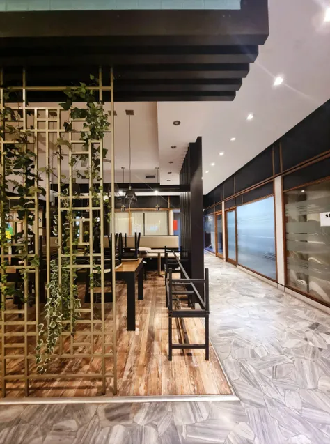 A view of a room with a table and chairs and a planter., modern lush condominium as a store front, restaurant interior photography, wooden walls, brass panels, Indoor Coffee, hidden area, Well-lit stylish environment, brass pipes in the walls, with natural...