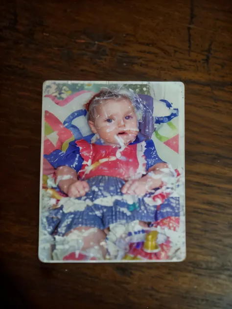 There is a picture of a baby in a photo on a table, 3D Photo, 3D Photo, restore photo, fix photo, heavy jpeg artifactñ, added detail, digital photography, Photographic scanning, high resolution scan, low quality photography, compressed jpeg, childhood memo...